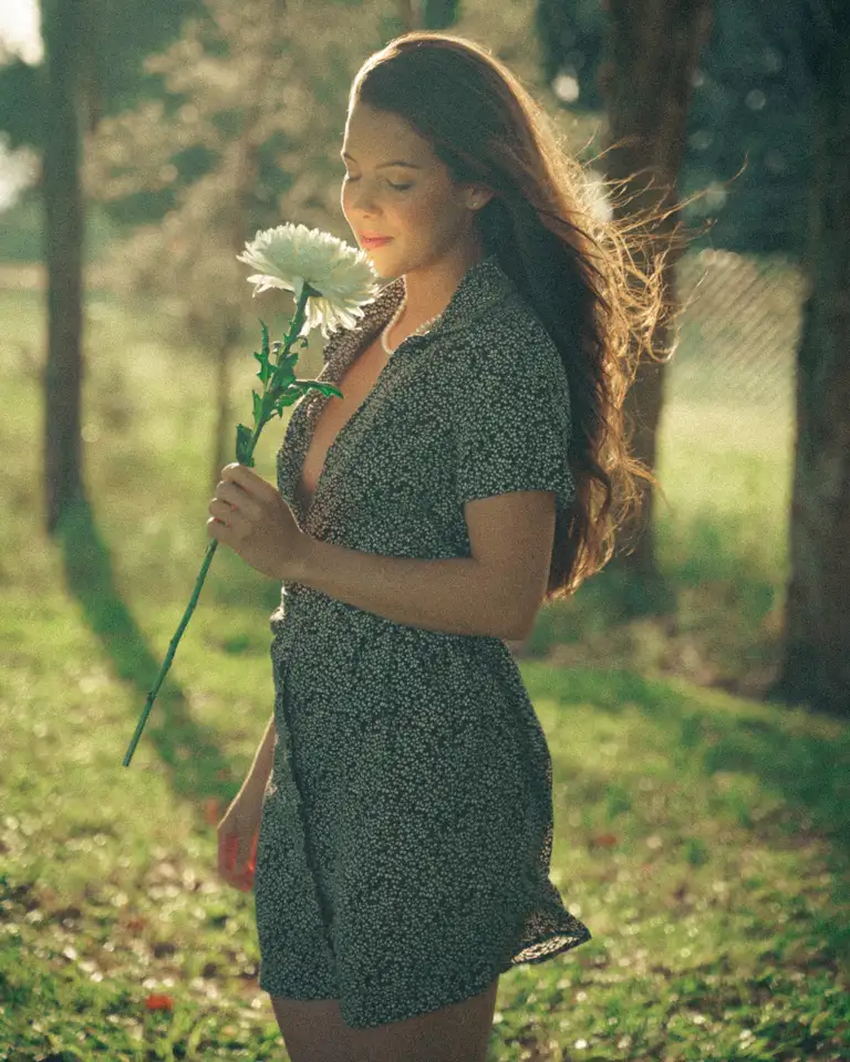 Outdoor fashion portrait of a model holding a white flower at sunset, photographed by a Gold Coast fashion photographer for a modelling portfolio.