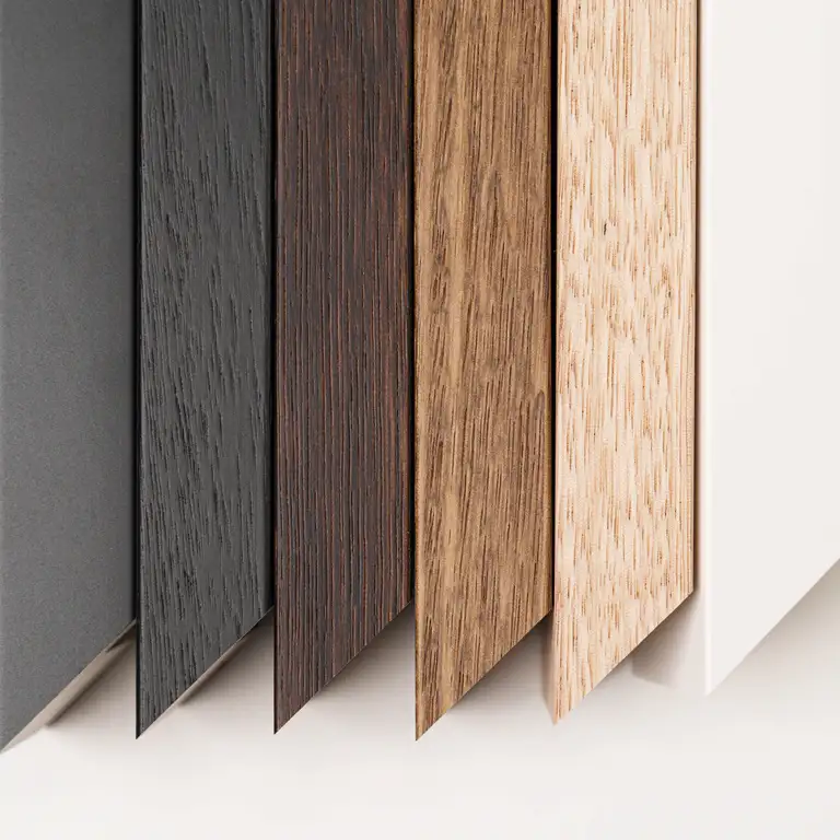 Close-up of art framing mouldings in black, oak, and white finishes, photographed in Australia to highlight texture and craftsmanship for fine art presentation.