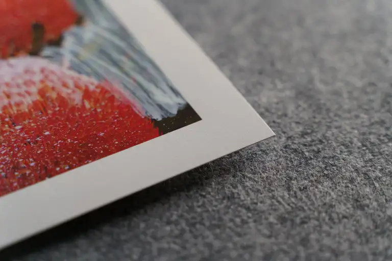 Macro photo of textured fine art print paper showing ink detail and tonal depth, captured under controlled studio light for eCommerce and archival display.