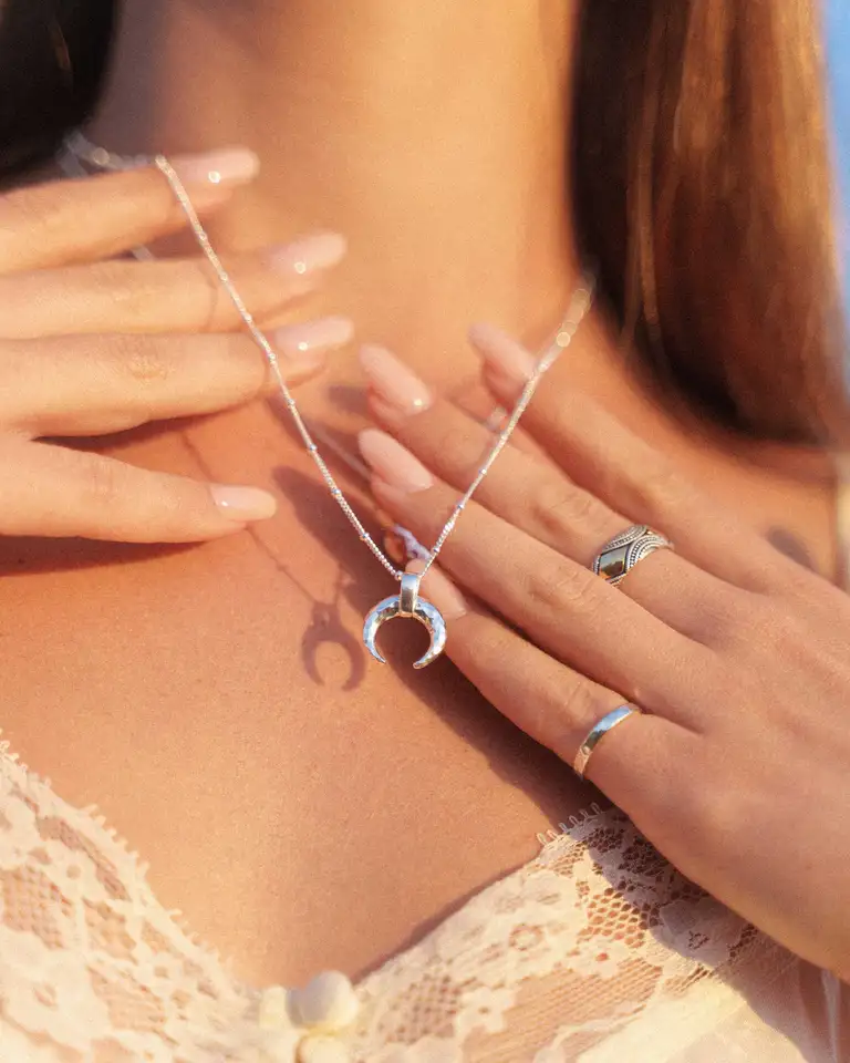 Lifestyle jewellery product photo showcasing bracelets and rings with soft, warm tones, photographed in England with a high-end eCommerce aesthetic.